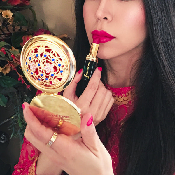 gold makeup mirror held in woman's hand-starfire cosmetics