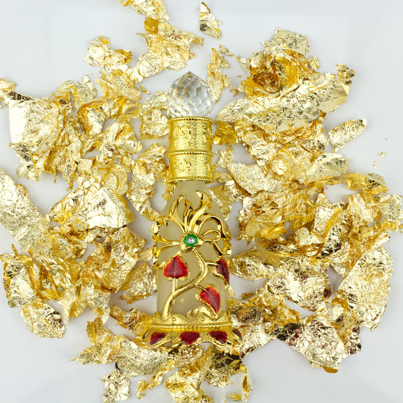 Gold flakes sprinkled next to crystal flowered dropper jar-starfire cosmetics