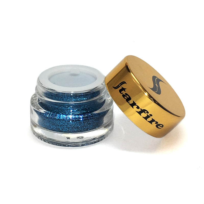 blue glitter inside glass jar with gold cap lid-starfire cosmetics