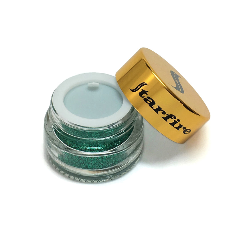 green glitter inside glass jar open with gold lid-starfire cosmetics