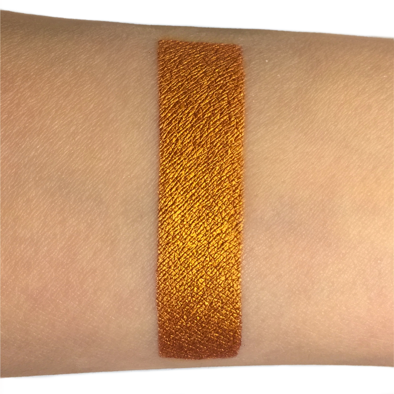 gold metallic liquid lipstick swatch on arm-starfire cosmetics